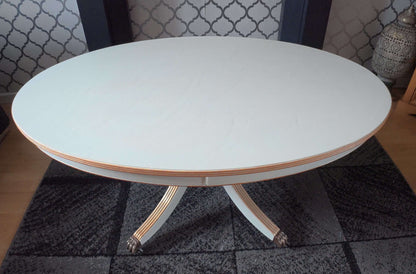 Oval white/grey table with gold trim.