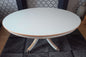Oval white/grey table with gold trim.